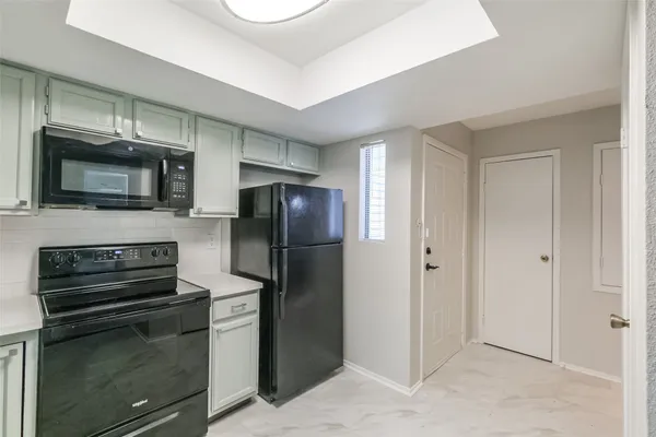 a kitchen with a refrigerator stove and microwave