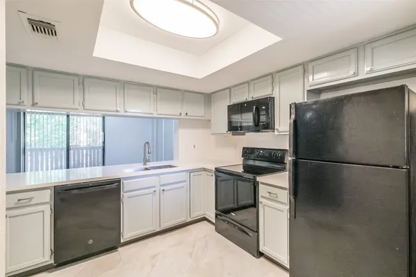 a kitchen with a sink stainless steel appliances and cabinets
