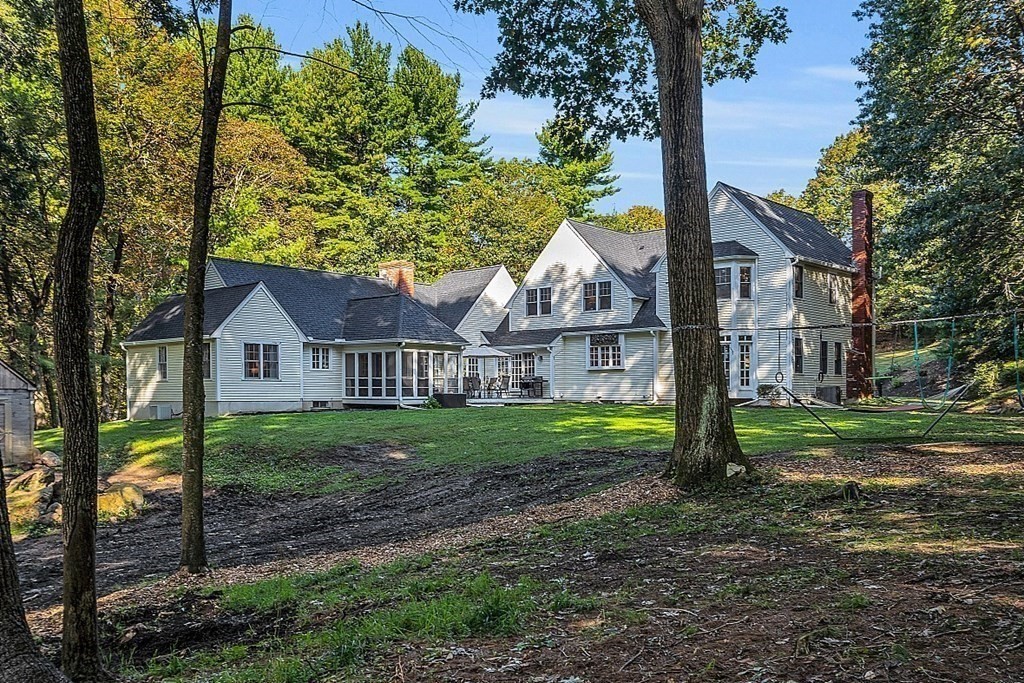 117 Channing Road Concord, MA 01742 - Photo 12 of 38 a view of house with a big yard and large trees