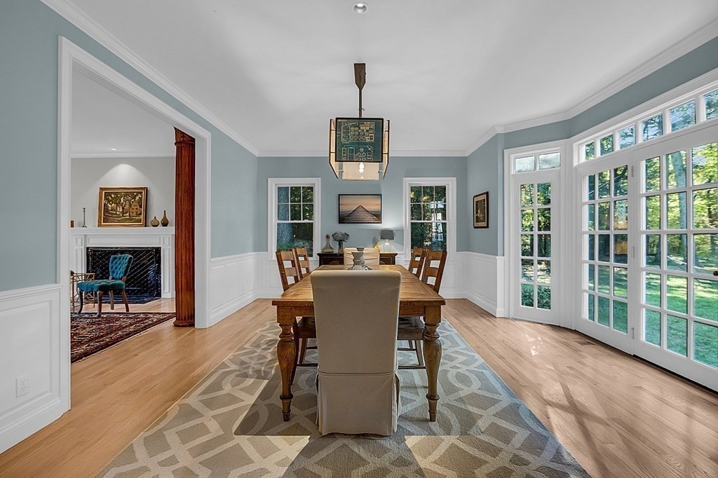 117 Channing Road Concord, MA 01742 - Photo 16 of 38 a dining room with furniture a fireplace and wooden floor