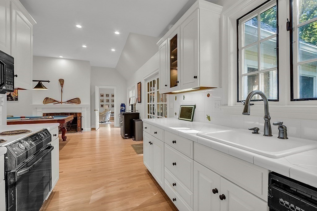 117 Channing Road Concord, MA 01742 - Photo 21 of 38 a large kitchen with stainless steel appliances granite countertop a sink and cabinets
