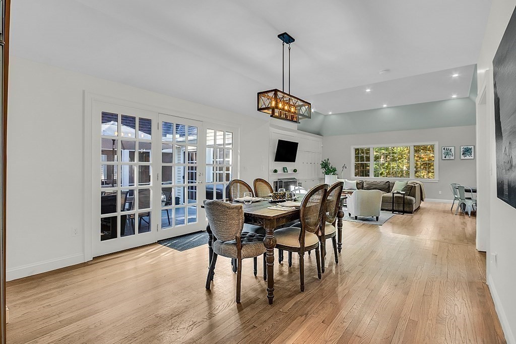 117 Channing Road Concord, MA 01742 - Photo 6 of 38 a view of a dining room and livingroom with furniture wooden floor a chandelier
