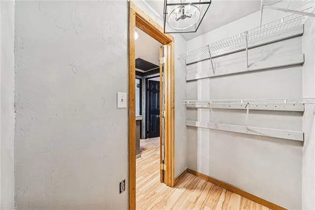 a view of walk in closet with empty racks
