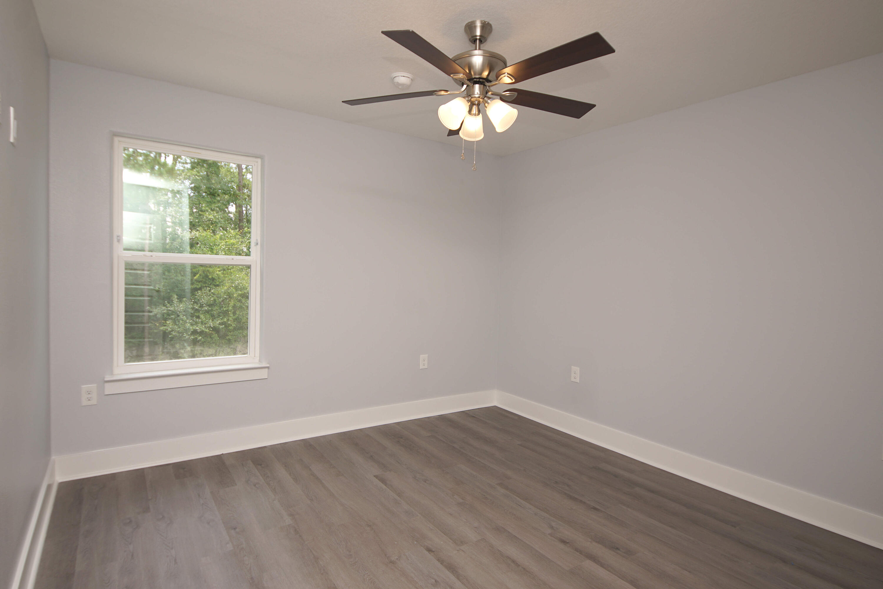 4514 Hermosa Road Crestview, FL 32539 - Photo 37 of 53 an empty room with wooden floor and windows