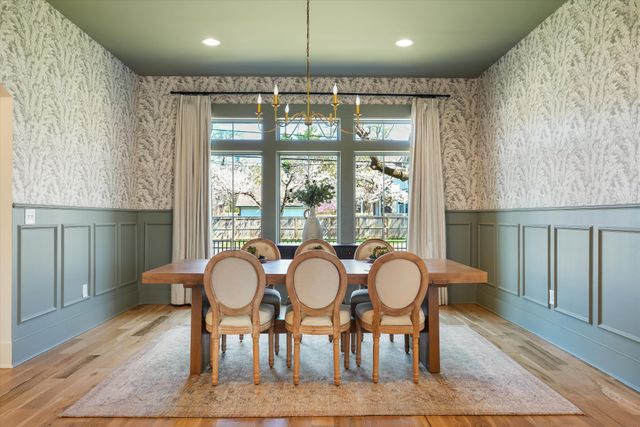 a kitchen with granite countertop a stove a sink and a white cabinets
