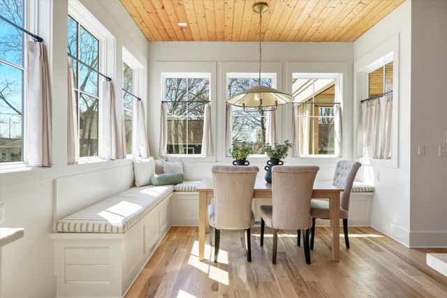 a living room with furniture and a potted plant with wooden floor