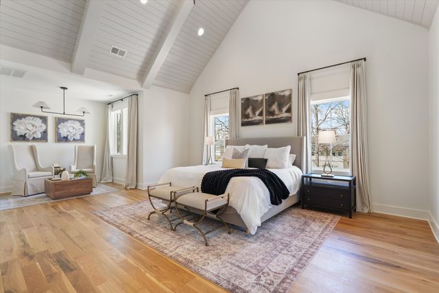 a en suite bathroom with a granite countertop sink and a mirror