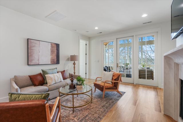 a view of a house with a yard and fence