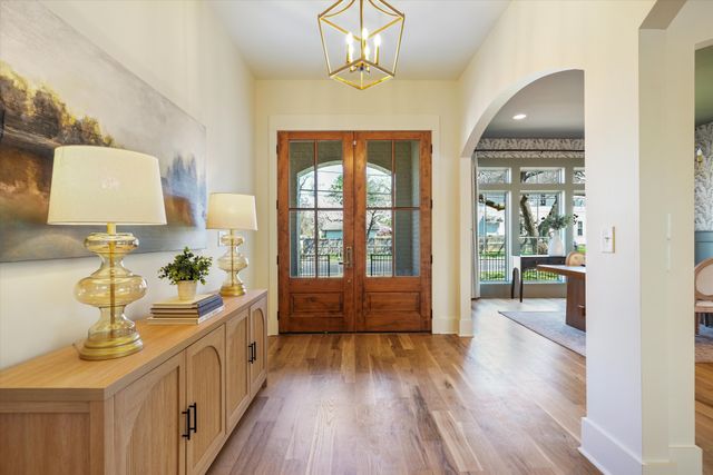 a room with painting on the wall and a wooden floor