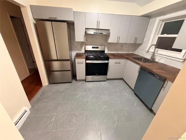 a kitchen with a refrigerator stove and sink