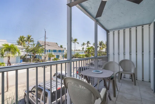 a view of a balcony dining area with furniture