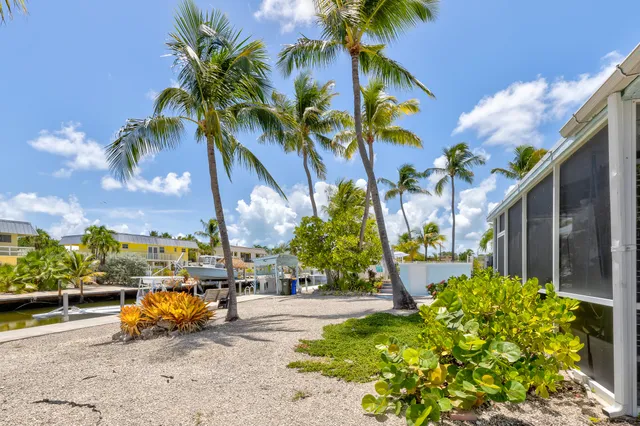 a view of a swimming pool with a table and chairs under an umbrella