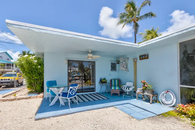 a view of a swimming pool with a lawn chairs and a swimming pool