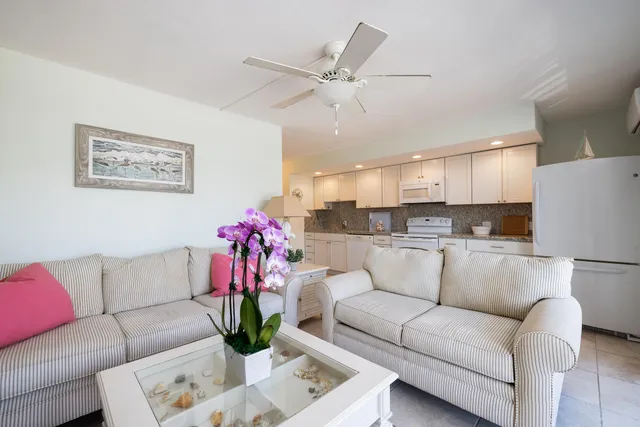a living room with furniture and kitchen view
