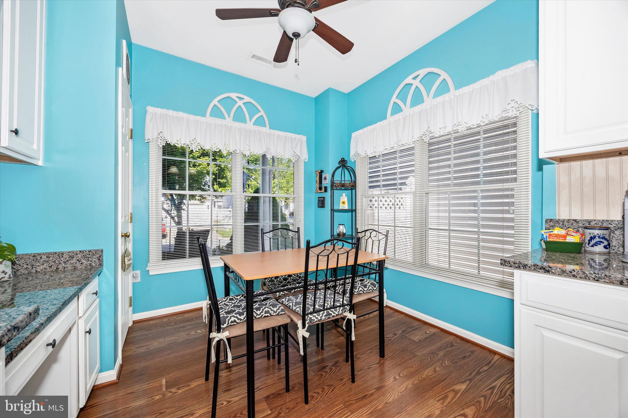 1005 Eastbourne Terrace Frederick, MD 21702 - Photo 15 of 39 a dining room with wooden floor a chandelier fan a wooden table and chairs