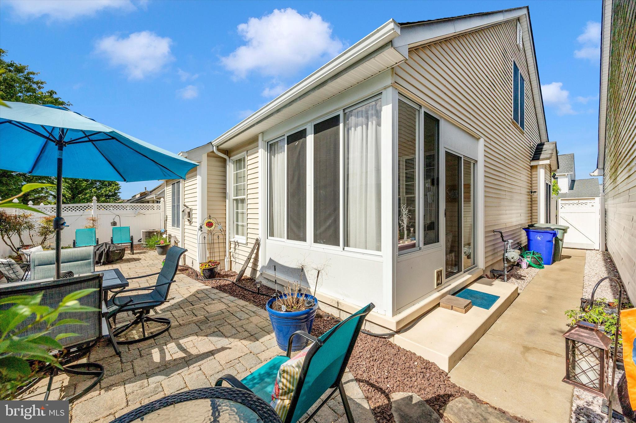1005 Eastbourne Terrace Frederick, MD 21702 - Photo 36 of 39 a view of a patio with couches table and chairs under an umbrella with a barbeque