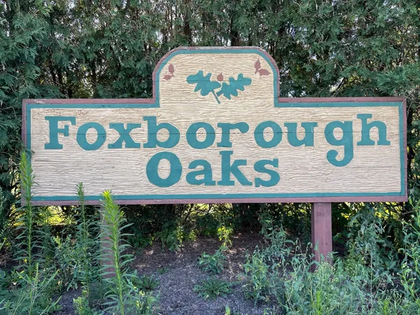 a view of a green field with clear tree