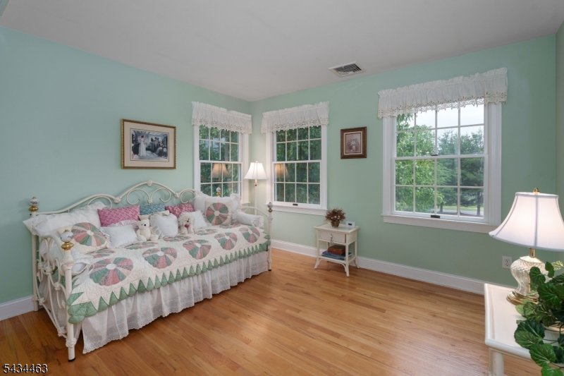 110 Orchard Road Skillman, NJ 08558 - Photo 29 of 43 a bedroom with a bed and wooden floor