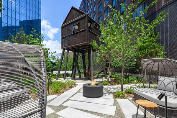 a view of a building with a yard and sitting area
