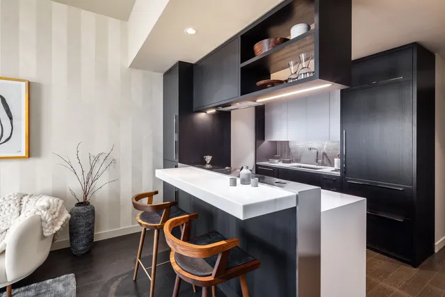 a dining room with table chairs and cabinets