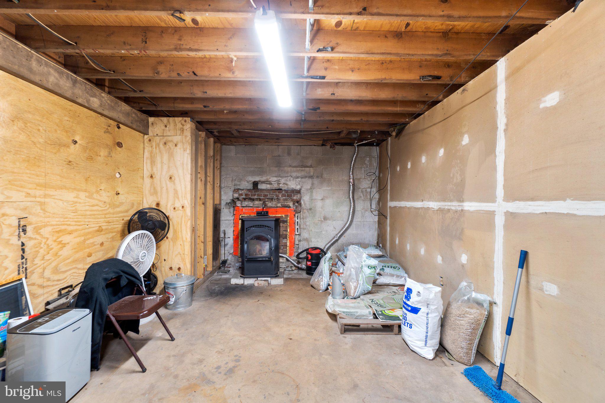 1970 Carrollton Road Finksburg, MD 21048 - Photo 26 of 43 Unfinished space w/ pellet stove 45' x 11'