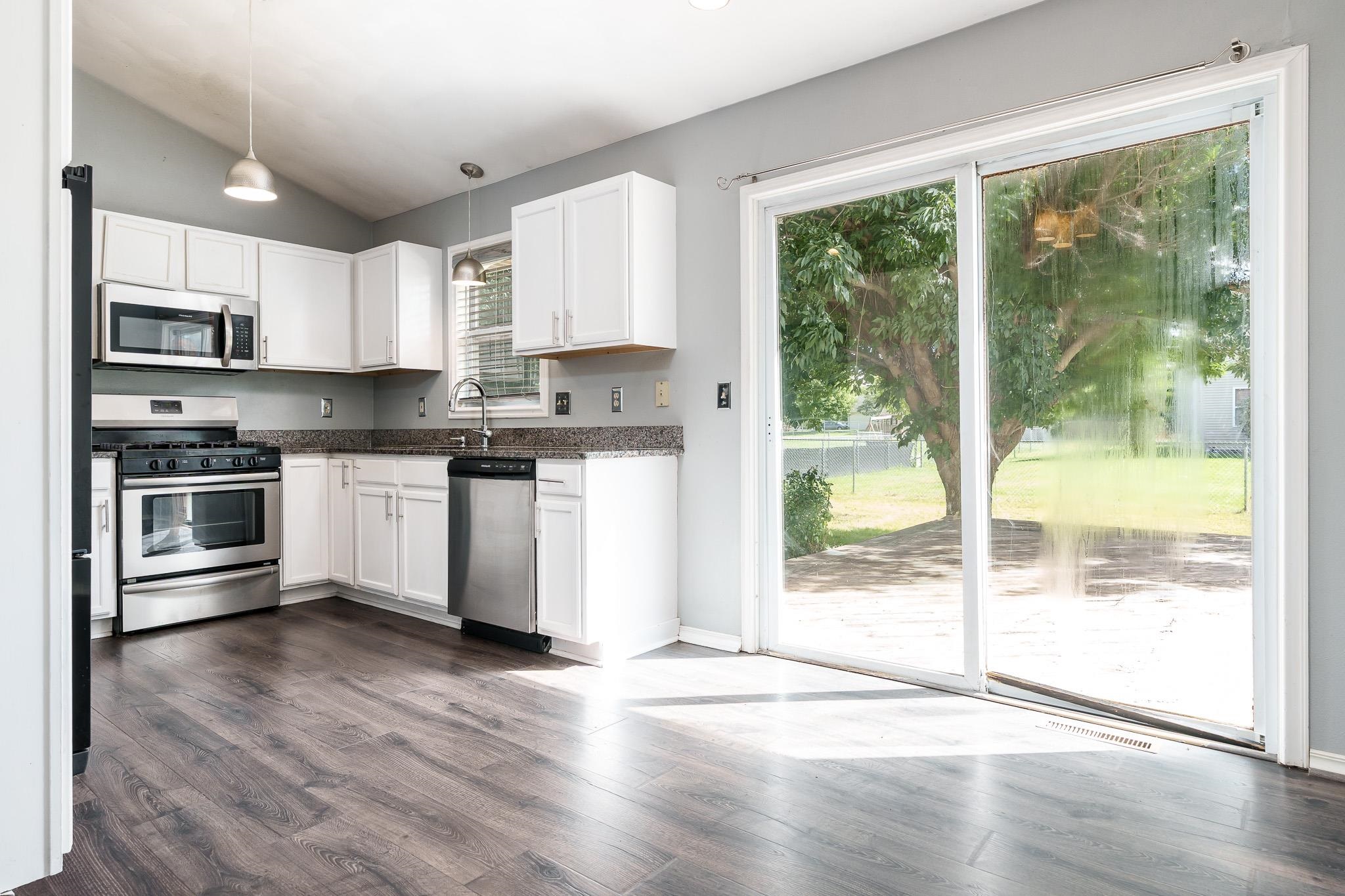 1996 Broadmoor Road Rockton, IL 61072 - Photo 17 of 45 a kitchen with stainless steel appliances granite countertop a stove a sink and a microwave