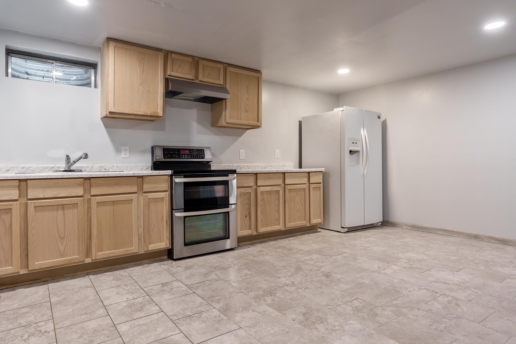 1996 Broadmoor Road Rockton, IL 61072 - Photo 44 of 45 a kitchen with stainless steel appliances granite countertop a stove a sink and a refrigerator