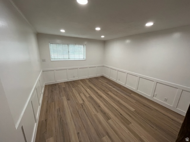 6884 670 East Midvale, UT 84047 - Photo 9 of 28 Unfurnished room featuring a decorative wall, a wainscoted wall, dark wood finished floors, recessed lighting, and ornamental molding