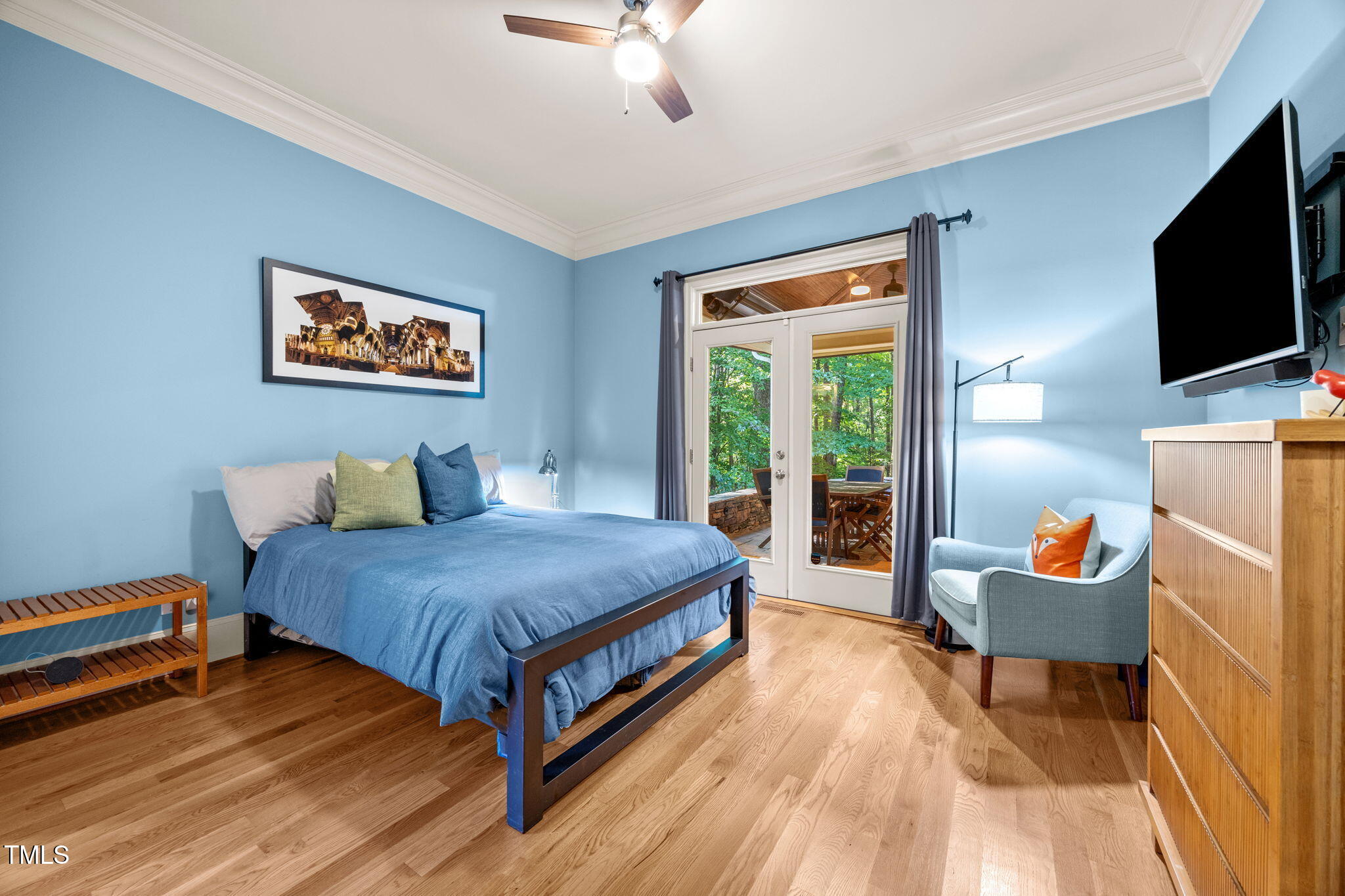 2409 Loring Court Raleigh, NC 27613 - Photo 16 of 60 a spacious bedroom with a bed and a flat screen tv