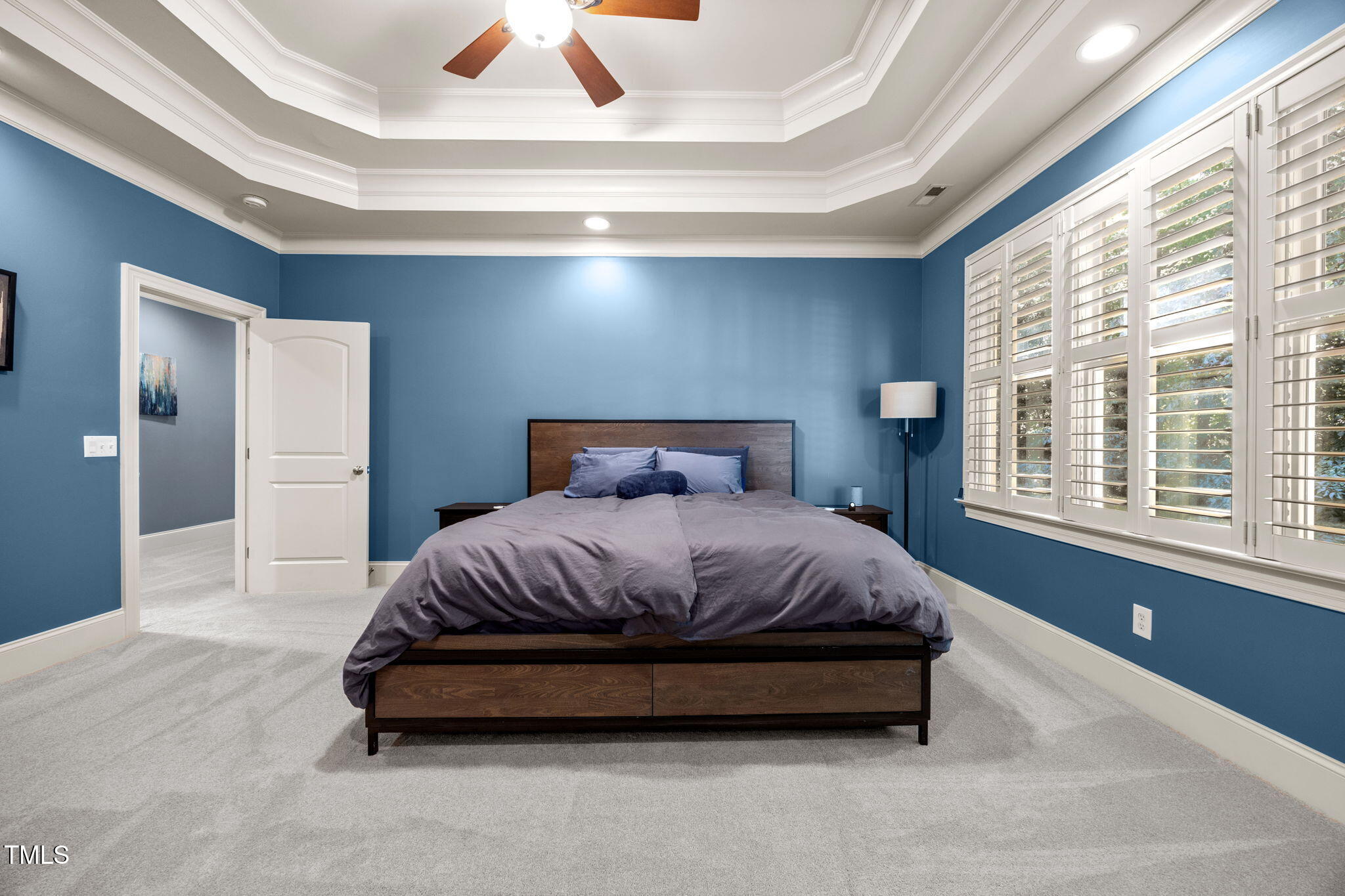 2409 Loring Court Raleigh, NC 27613 - Photo 21 of 60 a spacious bedroom with a bed and a large window