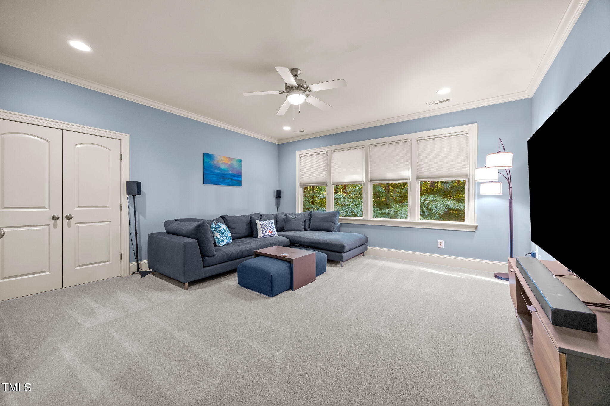 2409 Loring Court Raleigh, NC 27613 - Photo 39 of 60 a living room with furniture and a flat screen tv