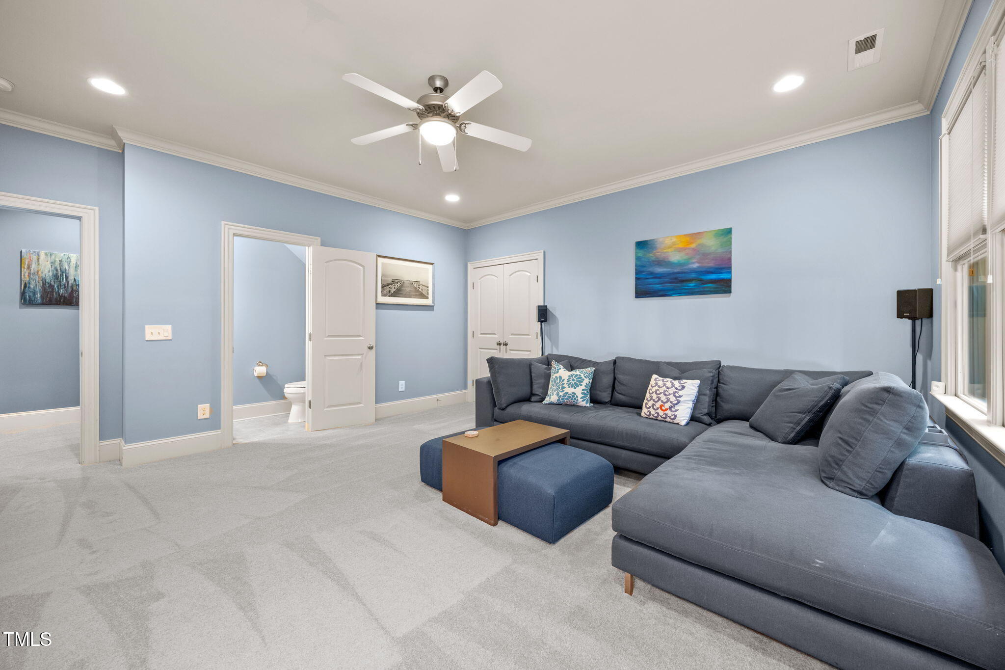2409 Loring Court Raleigh, NC 27613 - Photo 40 of 60 a living room with furniture and a ceiling fan