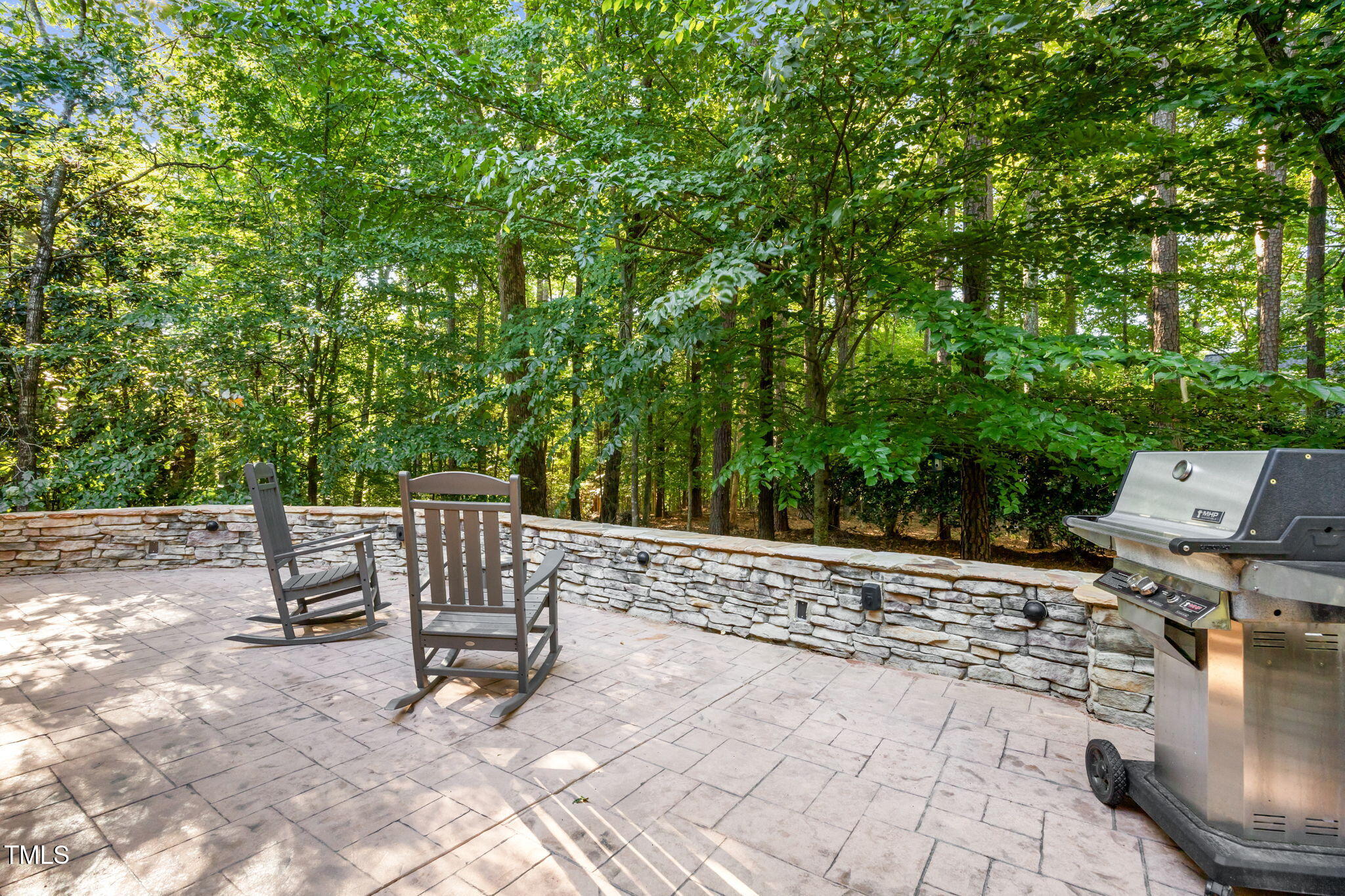 2409 Loring Court Raleigh, NC 27613 - Photo 43 of 60 a view of backyard with a table and chair