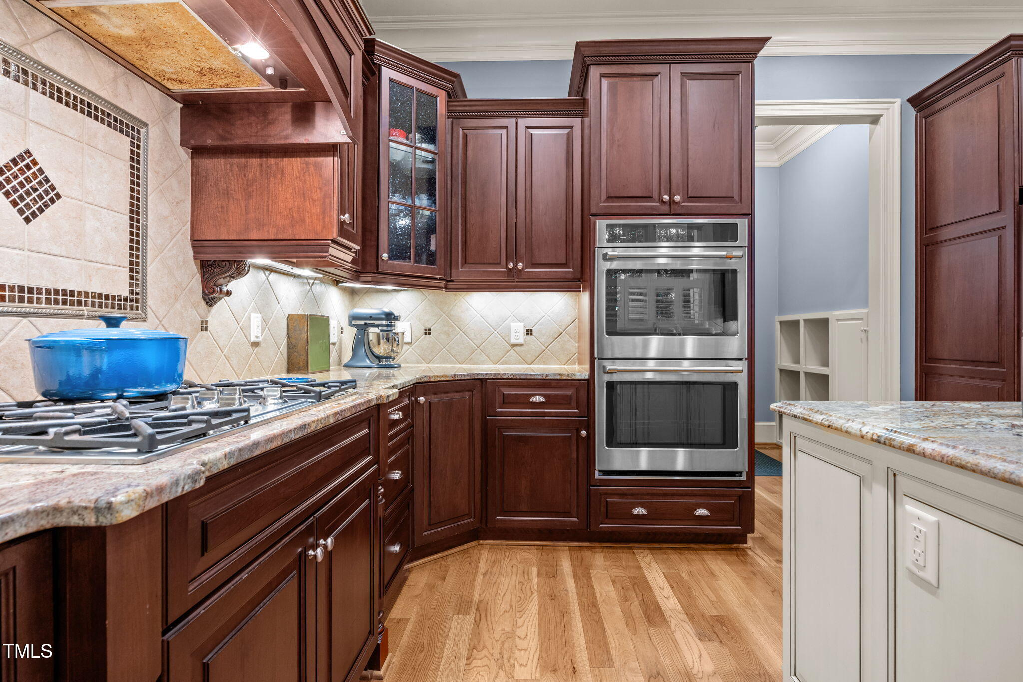 2409 Loring Court Raleigh, NC 27613 - Photo 9 of 60 a kitchen with stainless steel appliances granite countertop a stove a sink and a refrigerator