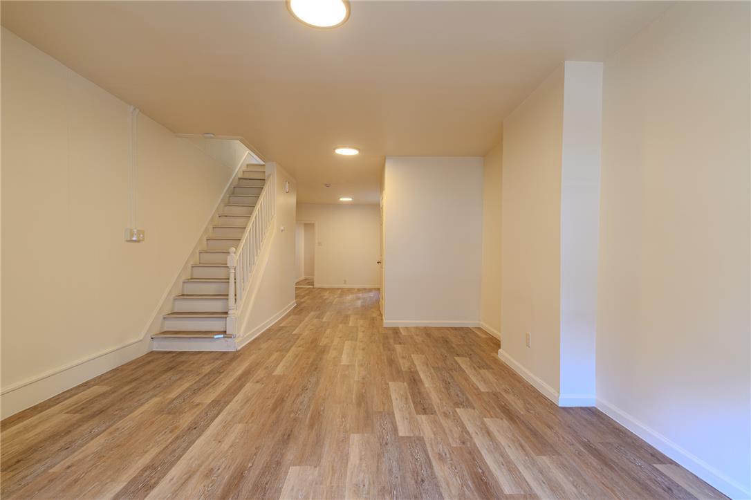 820 North 5th Street Allentown, PA 18102 - Photo 14 of 39 A versatile open space with rich flooring and a convenient staircase, ready for personal touches.