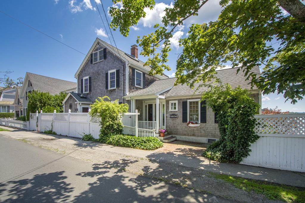 185 Downer Avenue Hingham, MA 02043 - Photo 2 of 30 a front view of a house with a yard and a garage