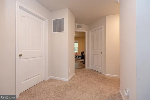 an empty room with closet and mirror