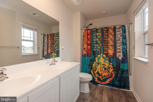 a bathroom with a sink toilet and window