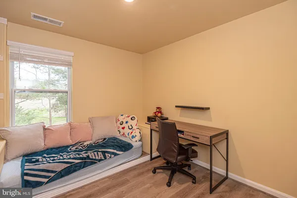 a view of a room with furniture and wooden floor