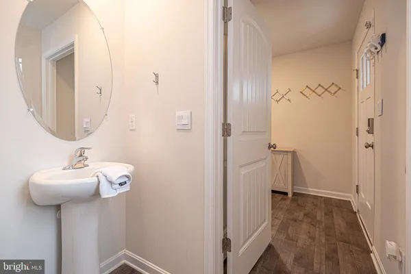 a bathroom with a sink toilet and mirror
