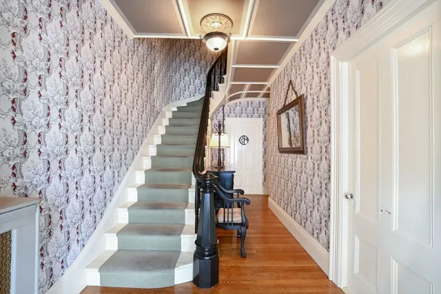 a view of entryway livingroom and hall with wooden floor