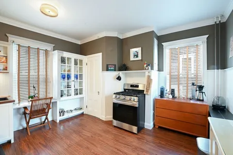a view of a kitchen with cabinets and wooden floor