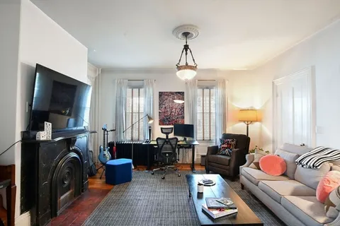 a balcony view with a couch and a potted plant on th table