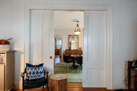 a front view of a house with outdoor seating and plants