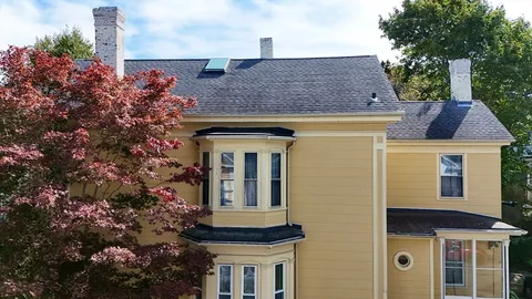 a front view of a house with a garden