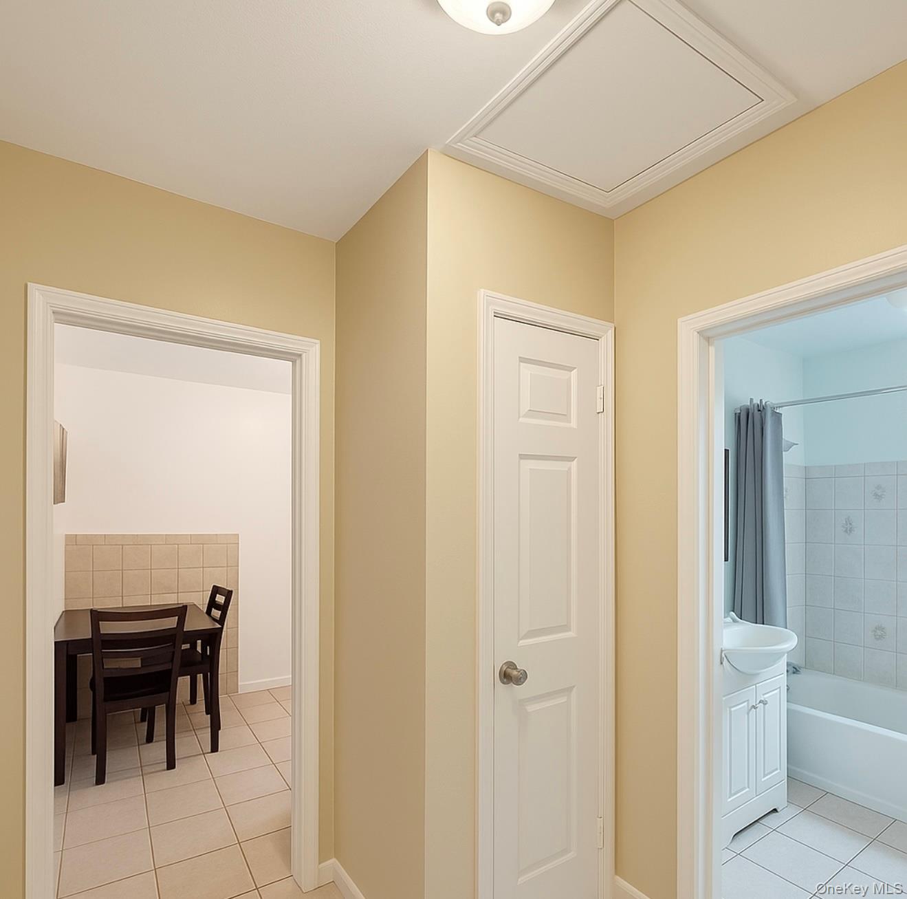 7103 252nd Street, Unit 199B Queens, NY 11426 - Photo 9 of 11 Corridor featuring light tile patterned floors and a sink