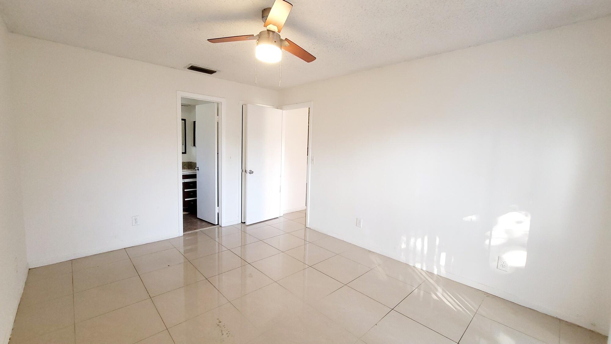 4049 Southwest 68th Way, Unit 6I Miramar, FL 33023 - Photo 22 of 32 an empty room with closet and a ceiling fan