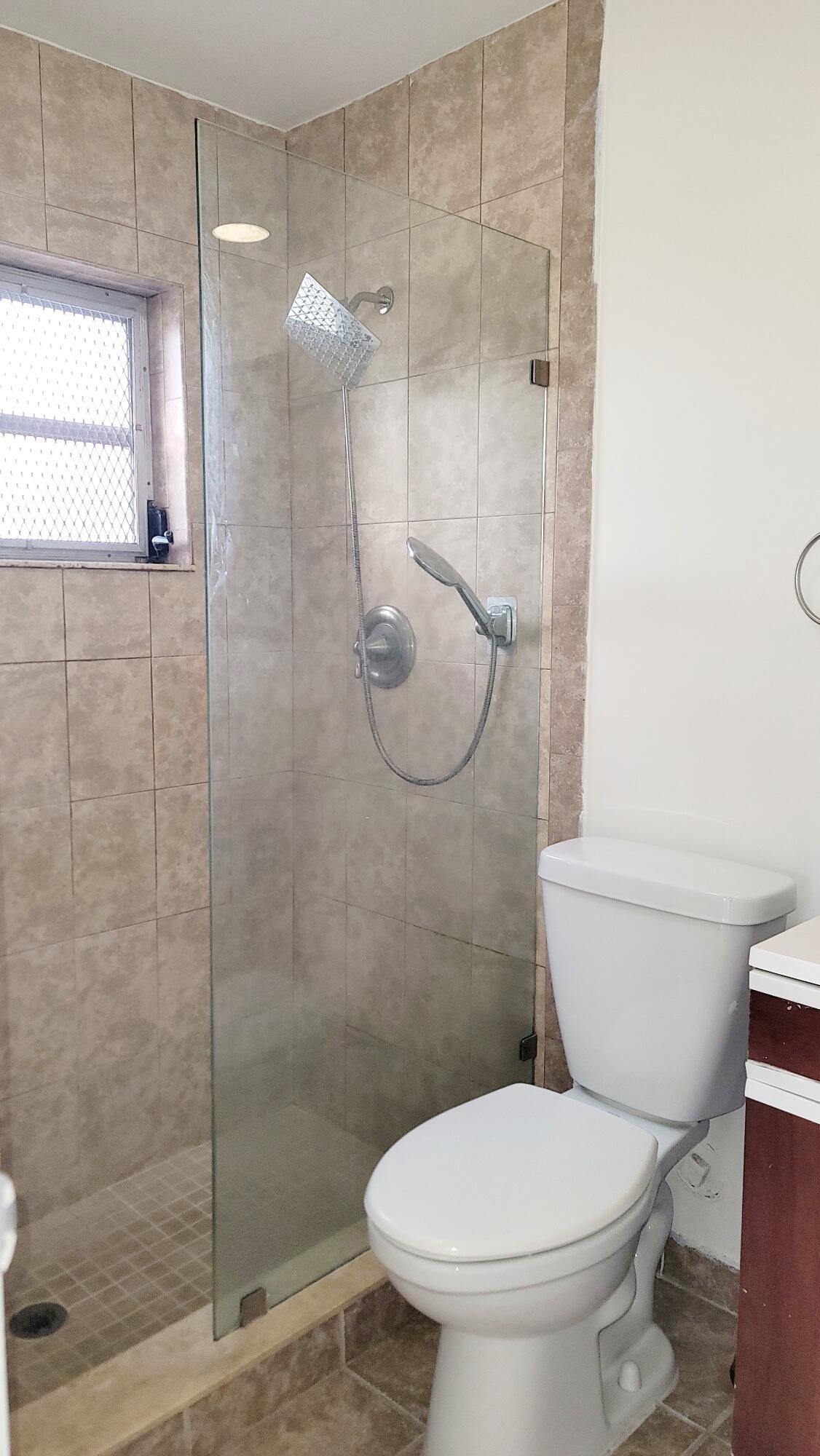 4049 Southwest 68th Way, Unit 6I Miramar, FL 33023 - Photo 25 of 32 a bathroom with a toilet and a shower