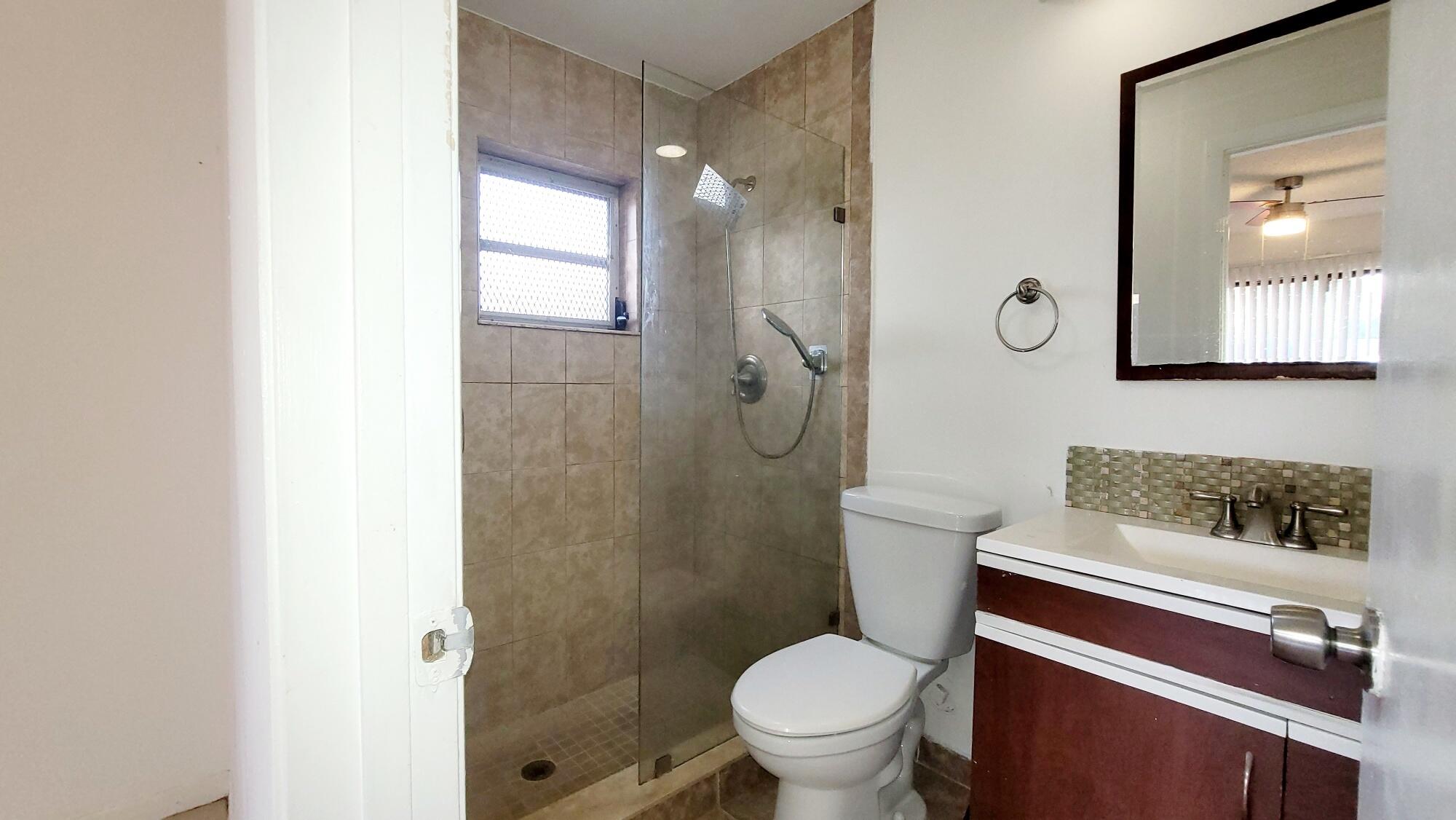 4049 Southwest 68th Way, Unit 6I Miramar, FL 33023 - Photo 26 of 32 a bathroom with a sink toilet and shower