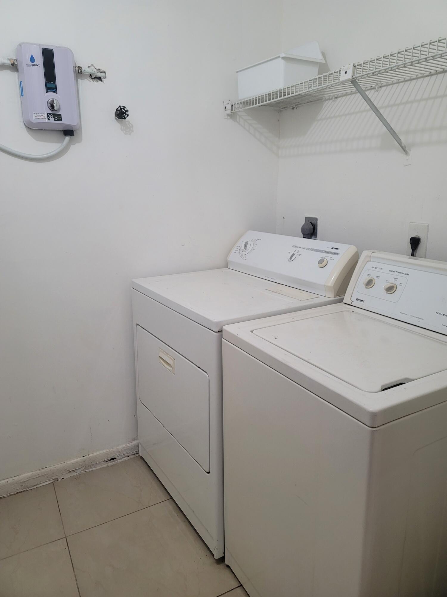 4049 Southwest 68th Way, Unit 6I Miramar, FL 33023 - Photo 29 of 32 a utility room with dryer and washer